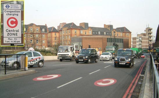 Street markings and a sign (inset) that alert drivers entering the charge zone at Old Street. The sign displays the original operating hours. 