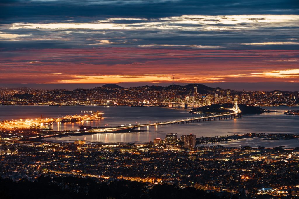 The skyline of San Francisco and Oakland is lit up at night