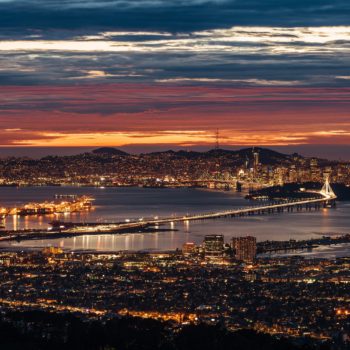 The skyline of San Francisco and Oakland is lit up at night