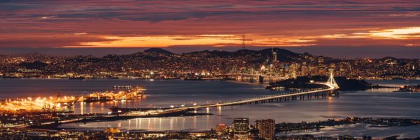 The skyline of San Francisco and Oakland is lit up at night